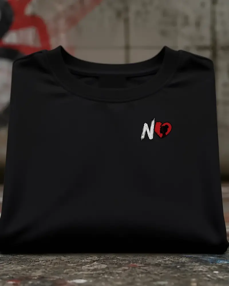 Concept mockup: black heavyweight tee with N and broken heart mark on the left chest